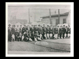 Group of stogie makers on Labor Day posed in front of the Union Automobile Company on 16th Street in Wheeling. Left cirkut of panoramic.