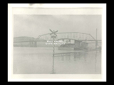 View of Ohio River bridge and railroad crossing sign during Wheeling flood.