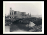 View of the Main Street stone bridge over Wheeling Creek and Baer's Sons Company building  at 16th and Main streets in Wheeling.