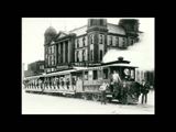 The Wheeling and Elm Grove Railroad  cars alongside the Ohio County and City Government building (former state capitol).