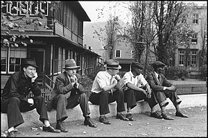 Men sitting on a curb